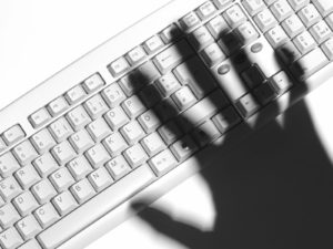 Human hand over keyboard