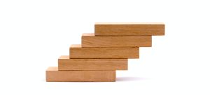 Blocks of wood arranged on top of each other to represent a hierachy