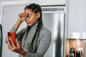 Unhappy woman looking at phone